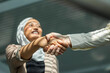 © ADDICTIVE STOCK - Business handshake with smiling Muslim woman in hijab