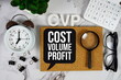 © may1985 - CVP - Cost Volume Profit acronym with calculator, alarm clock and magnifying glass, business concept background