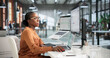 © Andrey Popov - Young Quality Manager Uses Laptop To Review Audit Reports