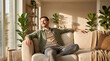 © FrameFlow - Young bearded man in casual clothes, neutral facial expression with closed eyes, sitting cross legged leaning back on white couch, sunlit living room with houseplants, domestic lifestyle photography