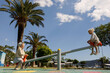 © Evgenij Yulkin/Stocksy - Kids swinging on a teeter-totter on a sunny day