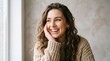© Karan - Happy young woman with long curly brown hair smiling and resting her chin on her hand portrait brunette cheerful