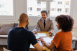 © BONNINSTUDIO/Stocksy - Financial advisor discussing financial planning with couple