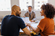 © BONNINSTUDIO/Stocksy - Couple receiving financial advice from professional advisor