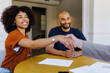 © BONNINSTUDIO/Stocksy - Couple shaking hands agreeing on business collaboration