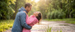© itlada - Happy couple laughing in the rain while wearing waterproof jackets in a green park during sunset, creating a romantic atmosphere perfect for relationship and outdoor lifestyle campaigns