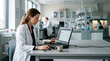 © Napaporn - Medical researcher in lab analyzing data on laptop with coffee and equipment