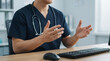 © Omid studio - doctor hand writing medical report on clipboard and reviewing patient document at hospital office with laptop. Concept healthcare administration, insurance claim analysis, and clinical prescription.