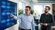 © Wool World - Two businessmen collaborating on a flowchart displayed on a large digital screen