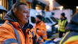 © Maksym - Night shift logistics team loading refrigerated delivery vans in cold storage facility parking bay, breath visible in freezing air, fluorescent dock lights illuminating coordinated movements, wareho