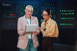 © Zamrznuti tonovi - Female it professionals communicating and analyzing data records in a modern server room, managing cloud computing systems
