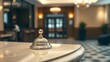 © yijin - Hotel reception desk with polished bell, elegant lobby in studio lighting.