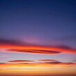 © intothestar - A wide panoramic view of the vast open sky at twilight, featuring deep blue gradients and soft orange clouds stretching across the horizon, majestic, horizon, celestial