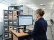 © nitinshankhwar - Female records manager reviewing digital retention schedules in modern archive storage facility