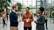 © ADDICTIVE STOCK - Diverse business people networking over coffee in office lobby
