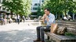 © Felippe Lopes - Man in Business Attire Eats Sandwich and Salad on a Bench in a City Park