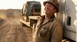 © Bluum - Smiling caucasian truck driver leaning against semi trailer carrying heavy construction machinery. Industrial worker in hard hat at remote job site during sunset. Logistics transport