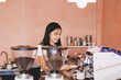 © ARMMY PICCA - Young woman at barista school learning how to make espresso coffee.