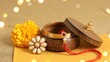 © Habiba Noor  Jannat - Traditional rakhi thread in a decorative wooden box with a yellow marigold flower for Raksha Bandhan festival