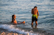 © Zoran Jesic - Children playing in ocean waves during summer vacation