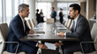 © Alice_Fame - Bribe paid under table at business meeting. Two businessmen exchanging white envelope under conference table in office. Corruption conceptual. Financial crime, money and secret deal concept copy-space