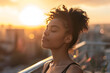 © Winston - Woman practicing breathing exercises on balcony at sunrise