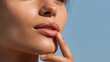 © JoeyMarut - Soft lips close up skincare lip balm application with fingertip and smooth skin in natural light