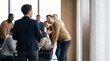 © Eve - Successful professional businesswoman presenting a financial strategy to a diverse group of smiling office coworkers during a corporate team meeting briefing in a modern bright workspace.