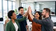 © Eve - Cheerful diverse multiethnic business team giving high five celebrating success in modern corporate office, happy young coworkers motivated by victory, showing unity and great teamwork.