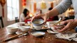 © hobonski - Removing traditional ceramic tea cups and bowls from a festive dinner table after a Lunar New Year family feast celebration.