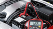 © Nakarin - Car battery testing with multimeter showing voltage reading 12.6 volts under hood of vehicle