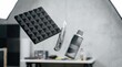 © 24DIY - A black acoustic foam panel utility knife and spray can are suspended in mid air