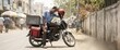 © Xenia - Exhausted Indian delivery courier resting on motorcycle in city street. Tired young man wiping sweat during hot summer heatwave