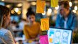 © Laura - Faceless startup team in a casual co-working space discussing product development, sticky notes and wireframes visible, inclusive and collaborative energy, defocused co-working