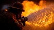 © GATE 22 - Firefighter wearing a helmet and protective gear, holding a hose and spraying water onto a large fire. the firefighter is standing in front of the fire, with the flames visible in the background.