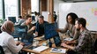 © DR Moura - Diverse team of professionals collaborating on a complex project using computers and flowcharts in a modern office setting