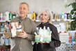 © JackF - When choosing bath cosmetic gift, mature couple gets acquainted with new product. Client compares products from different manufacturers, thinking about purchasing