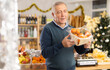© JackF - Elderly male shopper buying fresh tangerines in grocery store decorated for new year