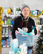 © JackF - On Christmas Eve, senior man buyer with filled basket household chemistry wanders around store, looking at display cases, inspects assortment and seek something at counter. .