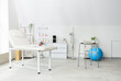 © Pixel-Shot - Modern physical therapy and rehabilitation clinic interior with examination couch, skeleton model, and exercise equipment