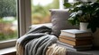 © Thares2020 - Cozy reading nook by window with gray knit blanket  stack of books  and potted plant on cushioned chair