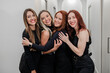© Austockphoto - Female aesthetic practitioners hugging each other inside the skin and laser clinic