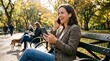 © CH - Young professional woman taking a video call on smartphone outdoors. Businesswoman in casual attire using mobile device for remote work meeting.