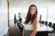 © PicStudio - Young attractive startup founder, elegant skirt, contemporary boardroom, innovation leadership session, executive confidence, professional business image.
