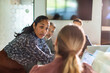 © Marko Geber - Businesswoman leading team discussion in office conference room