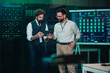 © Zamrznuti tonovi - It engineers reviewing server performance data on a digital tablet in a modern data center