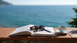 © Orapan - Open Novel and Sunglasses on Coastal Balcony with Cup of Coffee and Sea Horizon