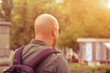 © Екатерина Переславце - Caucasian Bald Mature Man Back View with Backpack Walking in Autumn Sunset Park Solo Travel