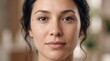 © Arpana - Frontal close-up portrait of a woman with dark hair showing natural skin texture and mild facial blemishes.