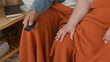 © Krakenimages.com - Man and plus size woman sit close on a couch, remote in his hand, orange blanket over laps, woman points at tv in a living room of a building; affection.
